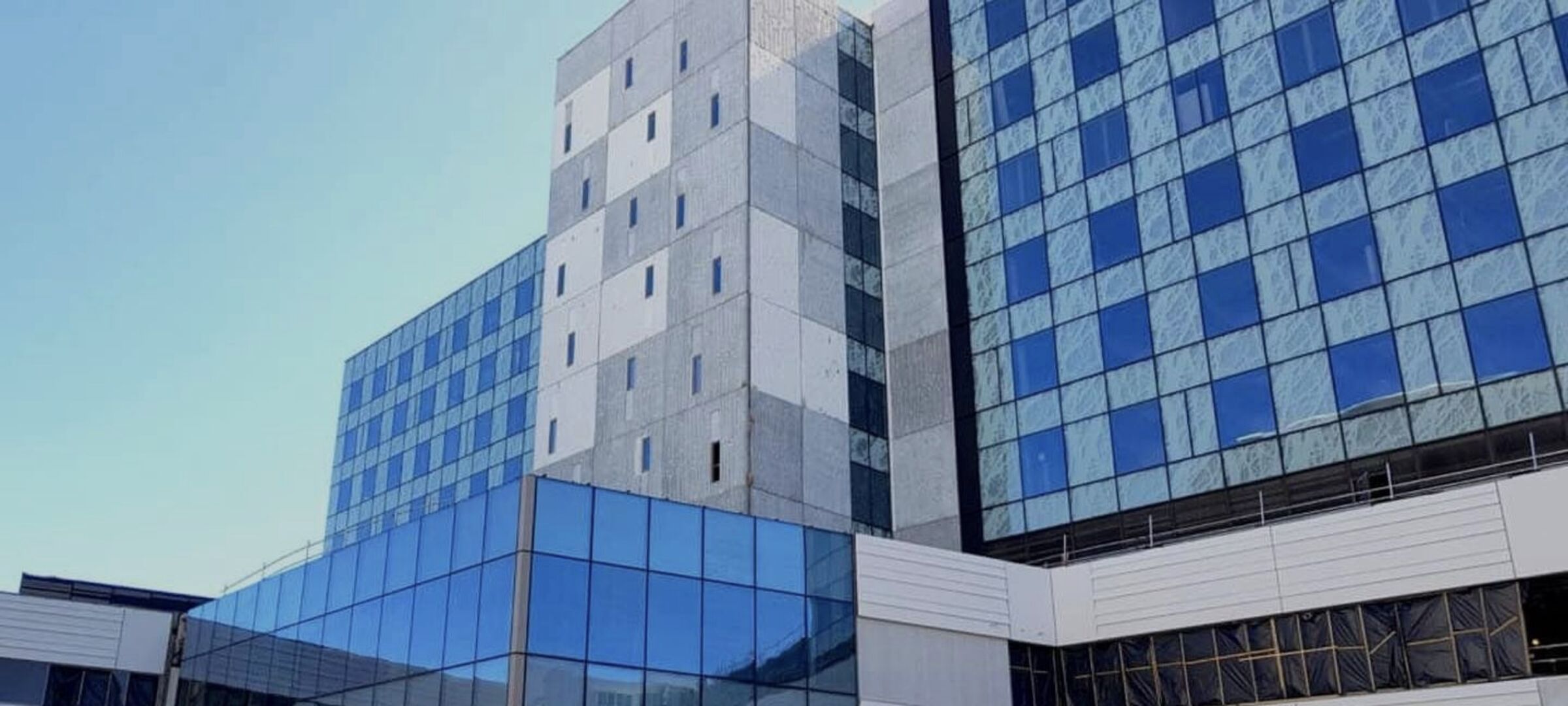 Christchurch Hospital's Waipapa acute services building, its glass facade reflecting the sky
